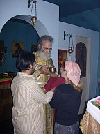 Fr Thomas giving Communion